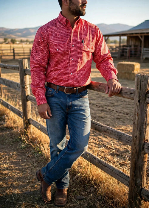 Alpha Red FR pearl snap work shirt worn with jeans and work boots at a ranch fence