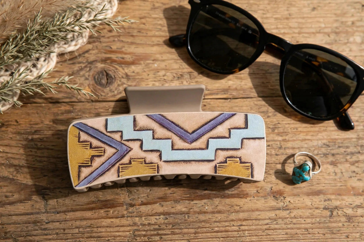 Western geometric hair claw clip flat-lay with sunglasses and a turquoise ring