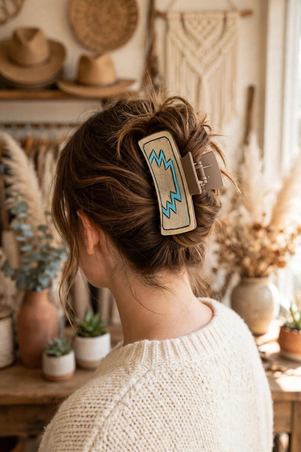 Turquoise Rodeo hair claw clip shown in a woman's updo at a western boutique