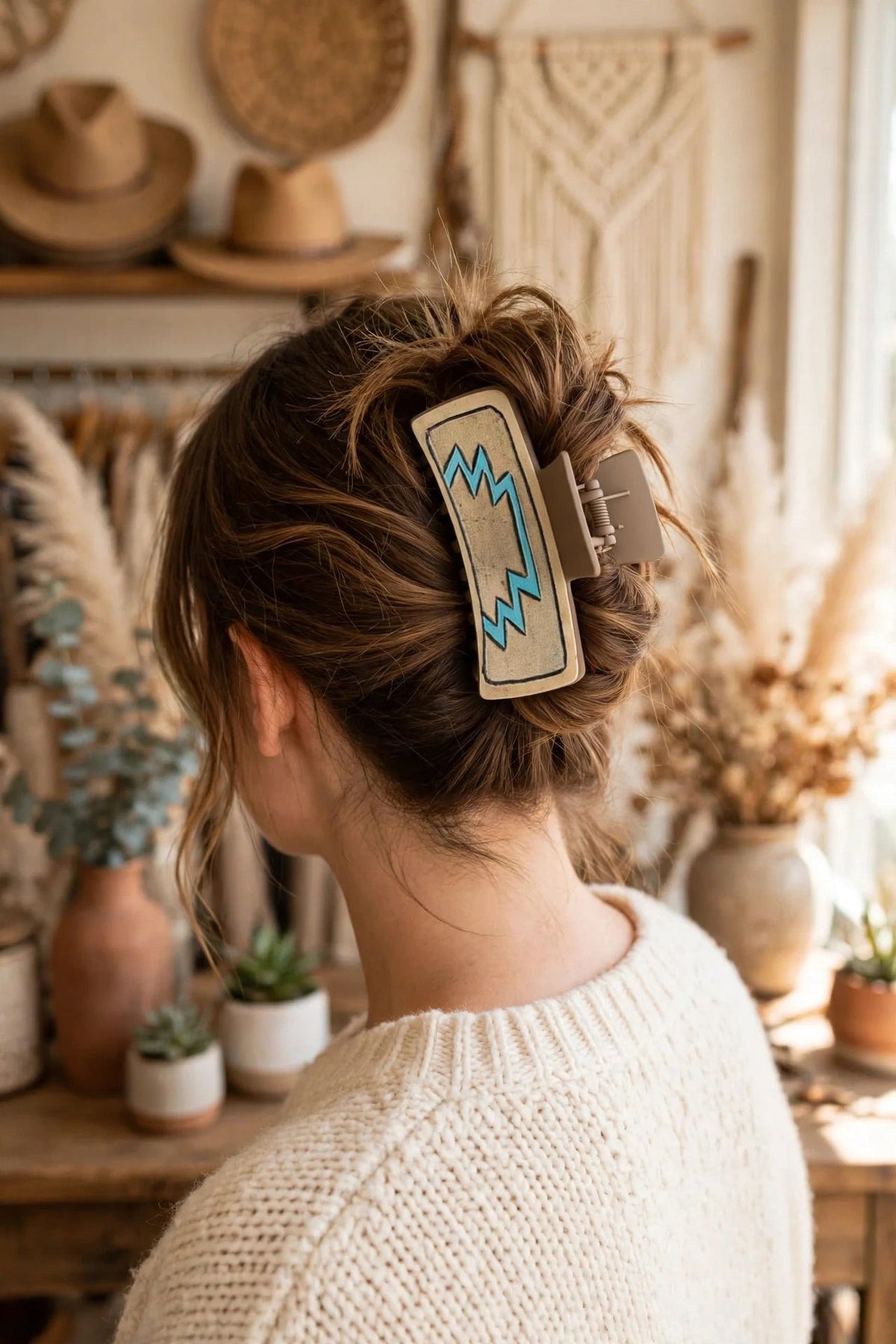 Turquoise Rodeo hair claw clip shown in a woman's updo at a western boutique